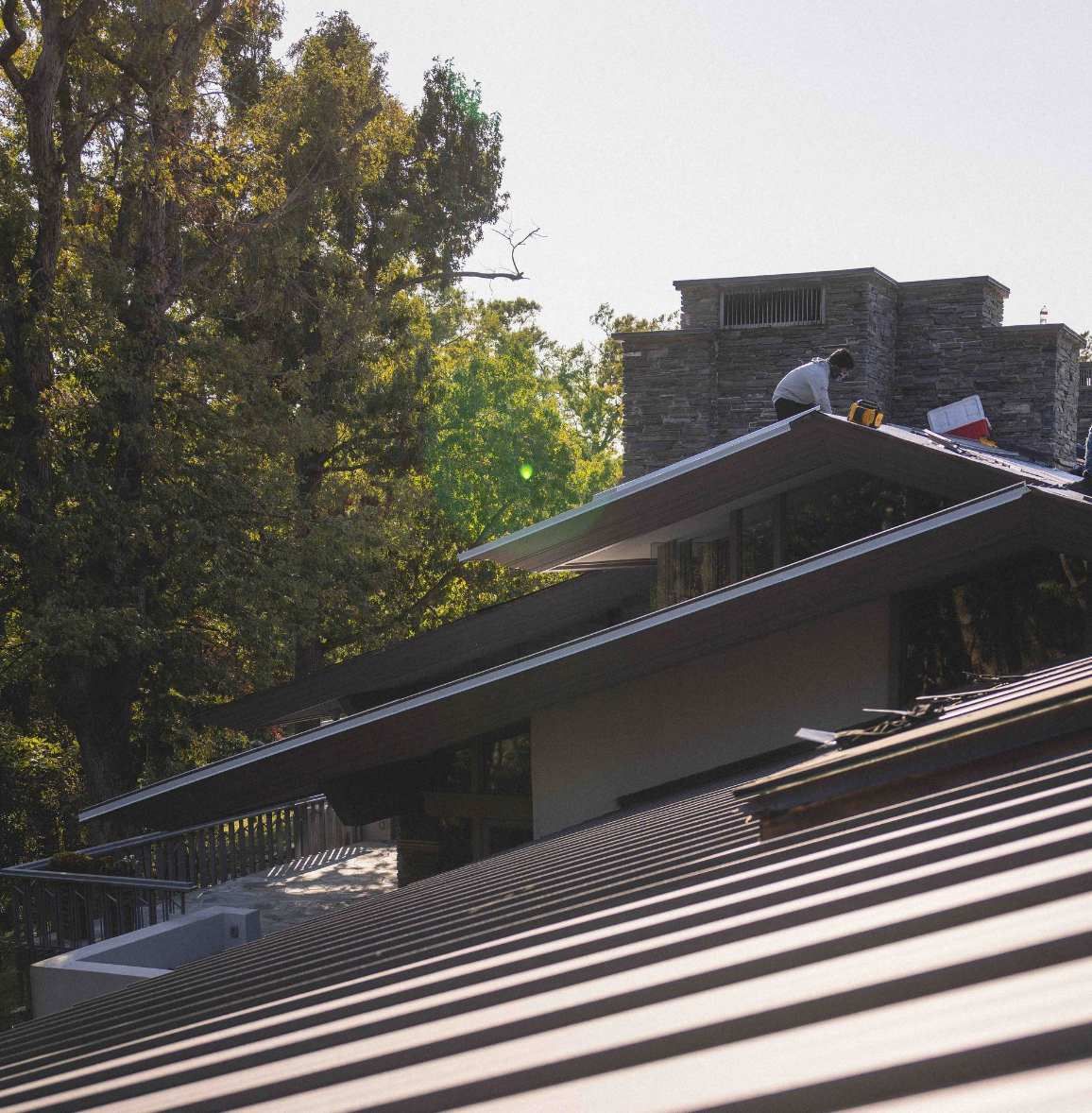 Crew installing standing seam metal roof